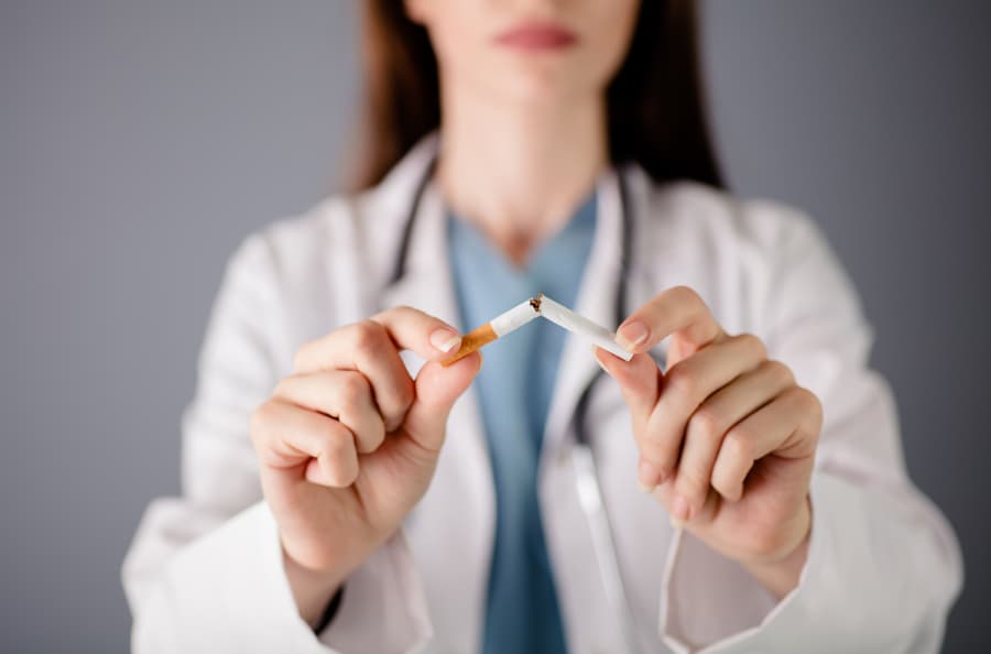 Doctor holding up cigarette broken in two pieces