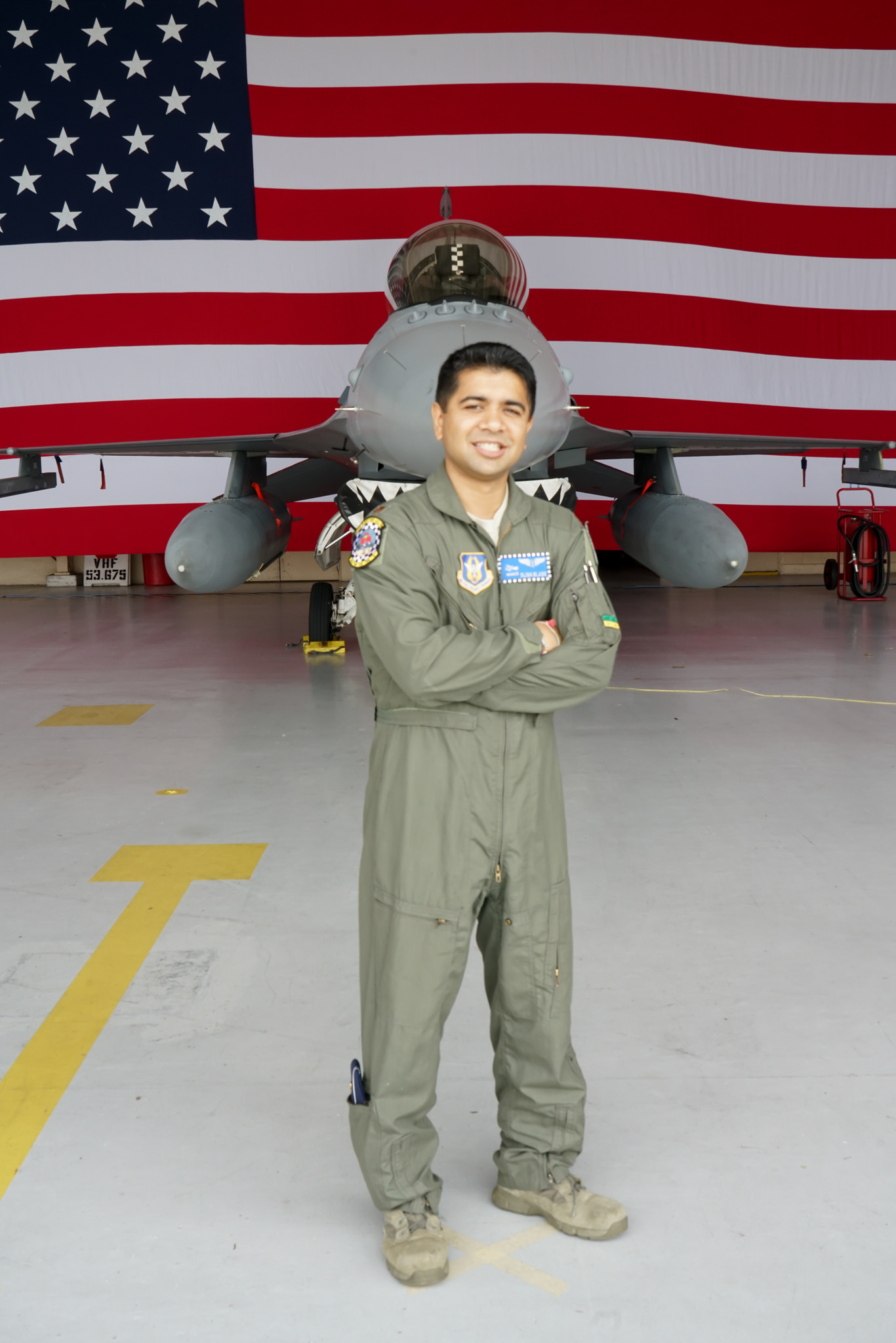 Dr. Kumar and an F-16 fighter jet.