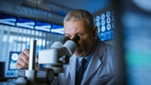 Medical-scientist-looking-through-microscope